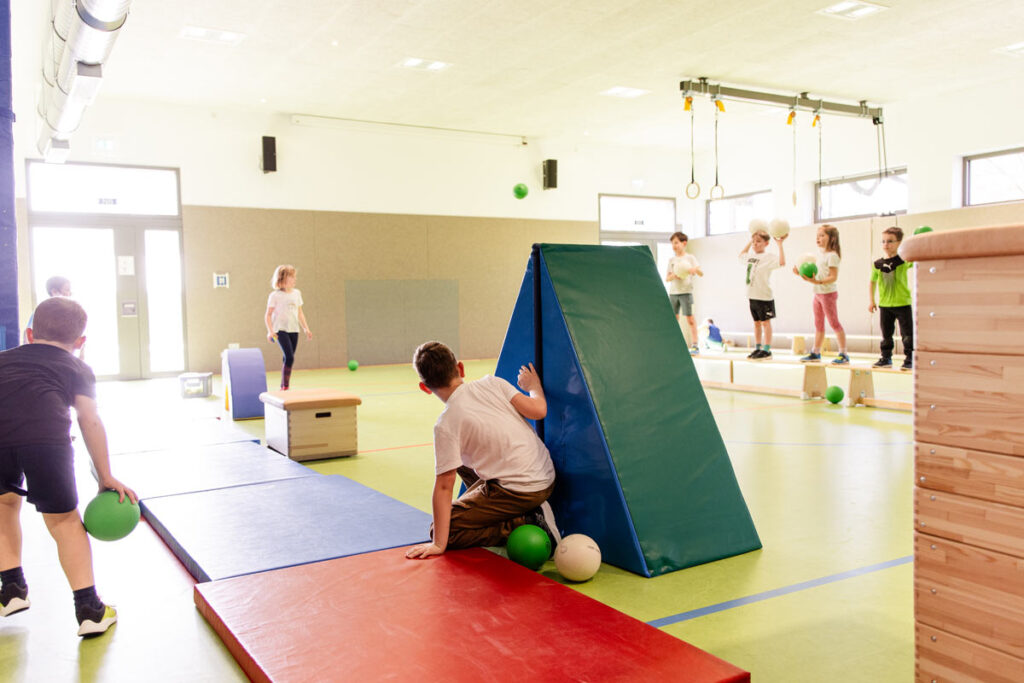 Kinder bewegen sich aktiv im Sportunterricht der katholischen Grundschule Celle zur Förderung von Gesundheit und Bewegung.